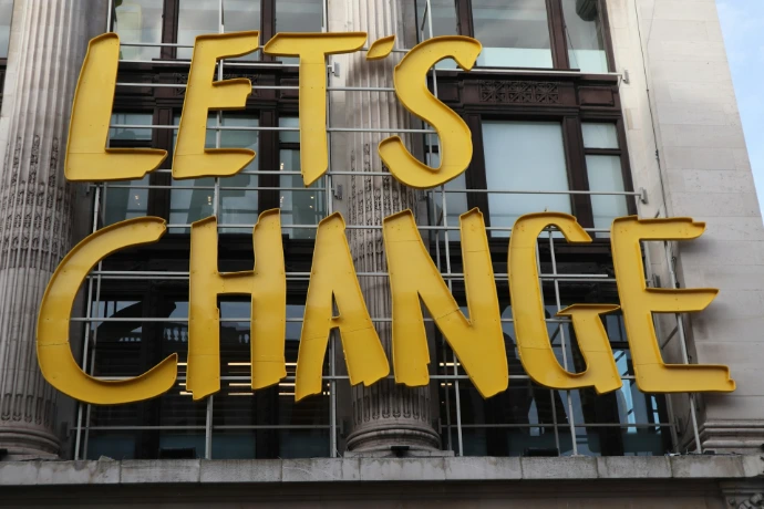 a sign that says let's change on a building